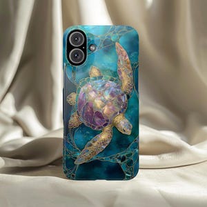 May include: A phone case featuring a sea turtle design. The case has a teal background with a stained glass effect and gold outlines. The turtle is depicted with iridescent purple, gold, and blue hues.