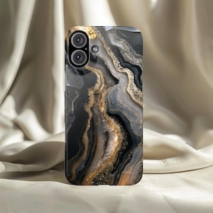May include: A smartphone case with a marbled design in shades of black, gray, and gold. The case has a glossy finish and features a dual-lens camera cutout. The design resembles natural stone with flowing patterns.