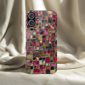 May include: A smartphone case with a mosaic design. The case features a pattern of small, irregularly shaped squares in shades of pink, gold, and brown. The camera lenses are visible at the top. The case is designed to fit a smartphone.