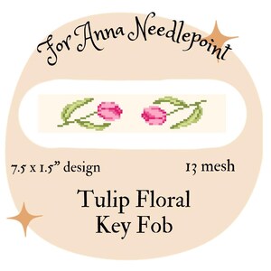 May include: A key fob design featuring a cross-stitch pattern of two pink tulips with green leaves. The design is 7.5 x 1.5 inches and is labeled "Tulip Floral Key Fob". The text "For Anna Needlepoint" is also present.