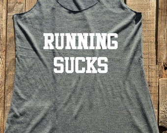 May include: Gray tank top with the text "RUNNING SUCKS" in white.