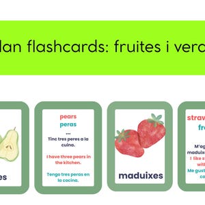 May include: Flashcards with the text "catalan flashcards: fruites i verdures". The cards feature illustrations of pears and strawberries, with text in Catalan, English, and Spanish. The cards are green with white text.