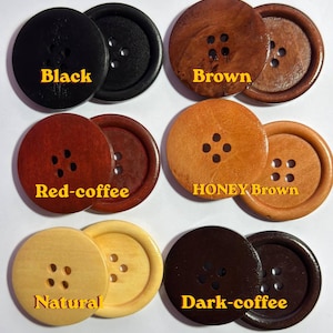 May include: A selection of wooden buttons in shades of black, brown, red-coffee, honey brown, natural, and dark-coffee. Each button is circular with four sewing holes. The colour names are printed on the buttons.