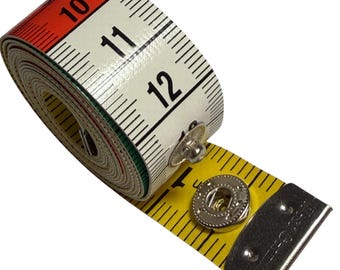 May include: A rolled white, red, and green measuring tape with black numbers and markings. The tape extends with a yellow section, featuring a metal end piece and a snap closure. Suitable for sewing and craft projects.