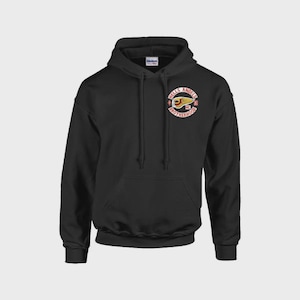 May include: A black hooded sweatshirt featuring a drawstring hood and a front kangaroo pocket. On the left chest, there is a circular emblem with the text Hells Angels MC Brotherhood and a winged skull graphic in red, white, and yellow colors.