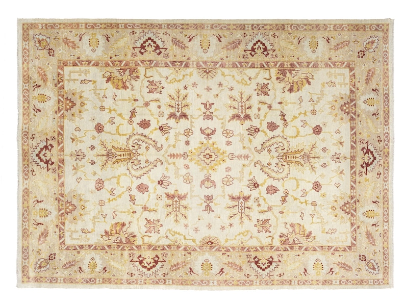 .Oversized vintage Turkish Oushak rug with a creamy ivory field, muted blush and golden ochre botanical motifs, and wide traditional floral borders.