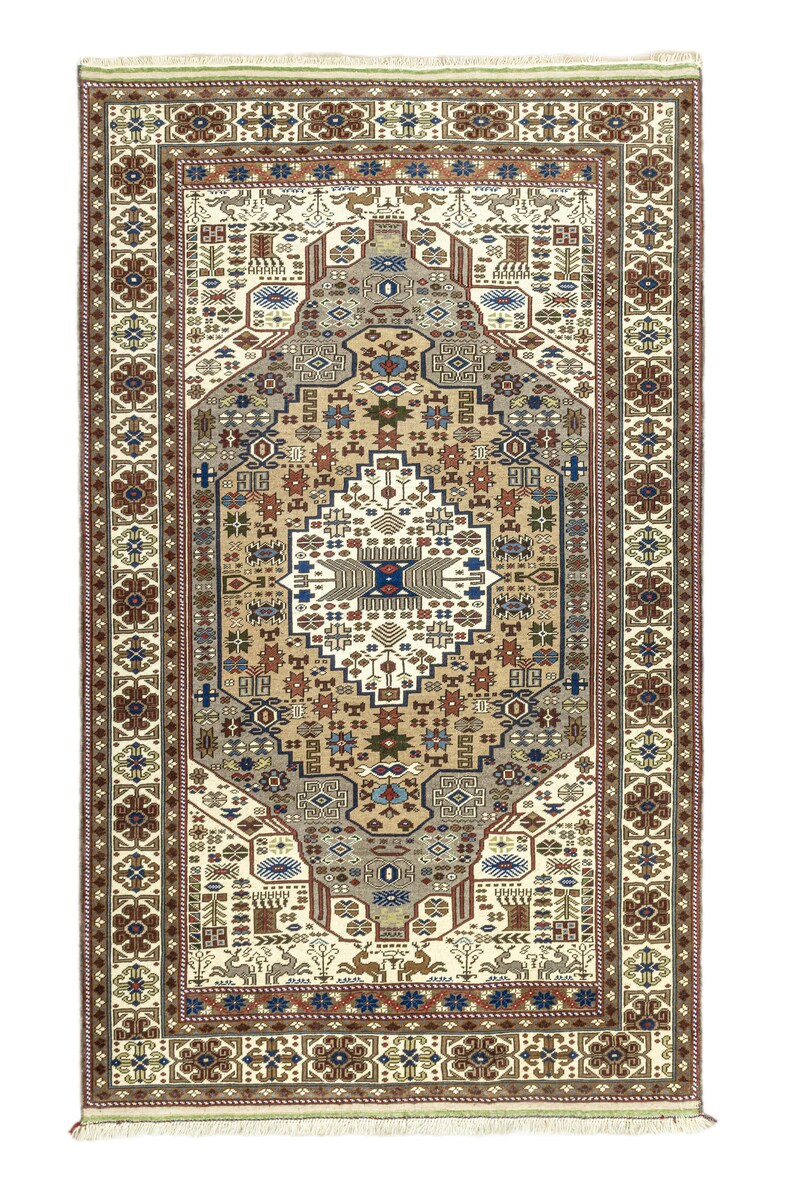 May include: A traditional rug with a cream background and intricate geometric patterns in shades of brown, red, blue, and green. The rug has a central medallion with a floral design and a border with repeating motifs.