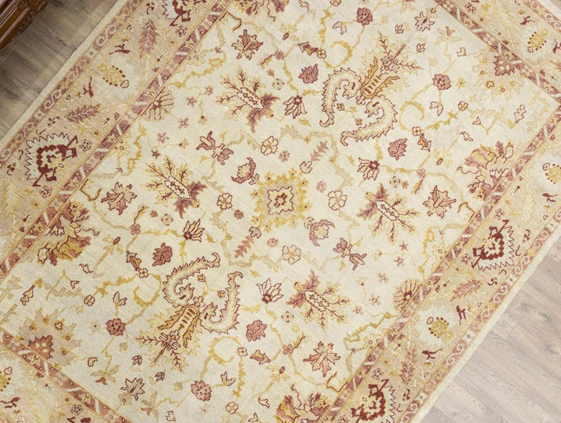 Vintage Turkish Oushak oversize rug 9.8x13.2 ft with creamy ivory base, blush gold tones, styled in elegant traditional living room