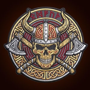 May include: A circular embroidered patch featuring a central human skull wearing a horned helmet, positioned in front of two crossed battle axes. The design includes intricate gold and red knotwork patterns and runic text in a circular border.