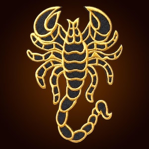 May include: An embroidered patch featuring a scorpion design. The scorpion is rendered in black thread with a prominent gold-coloured border and gold-coloured detailing that outlines the body, legs, pincers, and the curved, segmented tail.