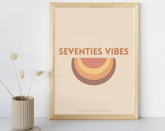 May include: A framed print with a beige background and the words "70's Seventies Vibes" in white and brown. A retro rainbow design is below the text. The frame is light brown.