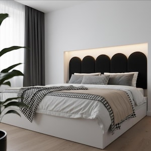 May include: A modern bed with a white base and a black arched headboard. The bed is made with white bedding, a houndstooth blanket, and decorative pillows. The headboard has a built-in light.