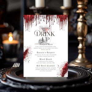 May include: A rectangular menu card titled Drink Up with a red glittery blood drip design at the top and bottom. The menu lists Vampire Kiss, Dracula's Daiquiri, Blood Punch, and Red Devil Cocktail with descriptions printed in black serif font.