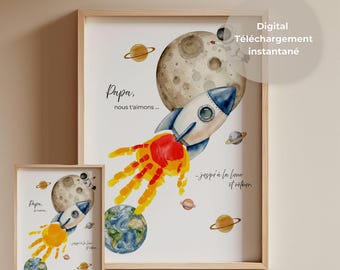 May include: A digital art print featuring a watercolor space scene with a rocket ship, planets, and an astronaut. The rocket exhaust is a handprint in red and yellow. Text reads: Papa, nous t'aimons... jusqu'à la lune et retour.