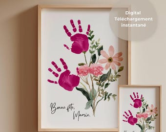 May include: Two framed prints featuring handprint art. The larger print displays two magenta handprints forming flower petals, with watercolor flowers and greenery. Text reads "Bonne fête, Mamie." The smaller print mirrors the design. Text on the image says "Digital Téléchargement instantané".
