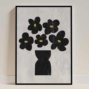 May include: Framed art print with a black vase silhouette holding black flowers with yellow centres. The artwork is set against a textured grey backdrop. A modern, minimalist floral design, ideal for home decor.