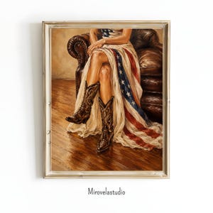 May include: Oil painting print of a person wearing a dress with the American flag design, seated on a brown leather couch. The person is wearing brown cowboy boots. The artwork is framed in a silver-colored frame. The artist's name, Mirovelastudio, is printed at the bottom.