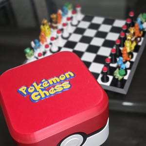 May include: A red and white Pokémon Chess set with a matching storage box. The box has the words "Pokémon Chess" in yellow and blue. The chess board is black and white with Pokémon character chess pieces.