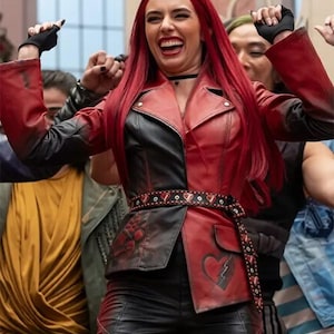 May include: A red and black leather motorcycle jacket featuring a notched lapel, a matching belt with heart-shaped studs, and a broken heart graphic on the lower left panel. The jacket has long sleeves, a front button closure, and a fitted silhouette.
