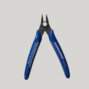 May include: Blue-handled wire cutters with the text "KAIHAOWIN" and "WEAR PROTECTIVE GOGGLES MAX.040" DIA. METAL WIRE" printed on the handles. The cutting blades are made of metal.