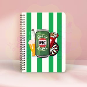 May include: Spiral-bound notebook with a green and white striped cover. The cover features a cartoon design with a beer can, a glass of beer, a dartboard, a cigarette, and the words "Piss Up Brawl" on the can.
