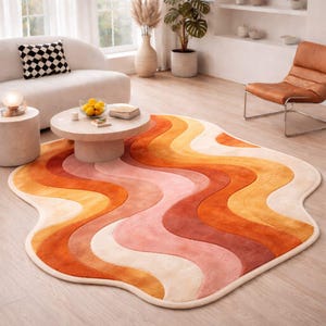 May include: A colourful, retro-style rug with a wavy pattern in shades of orange, pink, and cream. The rug has an irregular shape and adds a vibrant touch to the room. The rug is made of a soft, plush material.