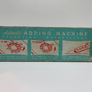 May include: Vintage Sterling Automatic Adding Machine box with operating instructions. The box is teal with white text and illustrations. Instructions include how to add and subtract using the dial.