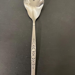 May include: A white ceramic mug with a black handle and the text "But First, Coffee" in a handwritten style. The mug is likely for hot beverages and has a glossy finish.