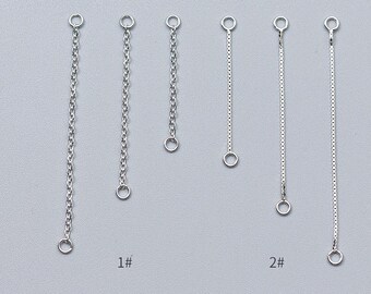 May include: Six silver extender chains with jump rings at each end. The chains are different lengths and styles. The chains are labeled 1# and 2#.