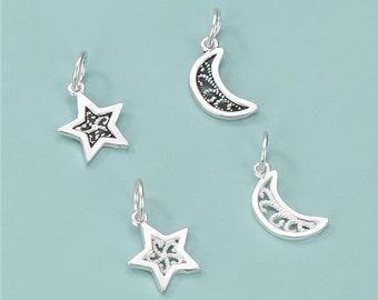 May include: Four silver charms, two star-shaped and two crescent moon-shaped, with intricate filigree designs. The charms are perfect for adding a touch of whimsy to jewelry or crafts.