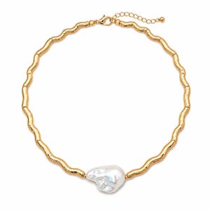 May include: A gold-toned necklace with a wavy design and a large, irregular white pearl pendant. The necklace has a delicate chain and clasp, and the pearl is centered at the bottom of the necklace.