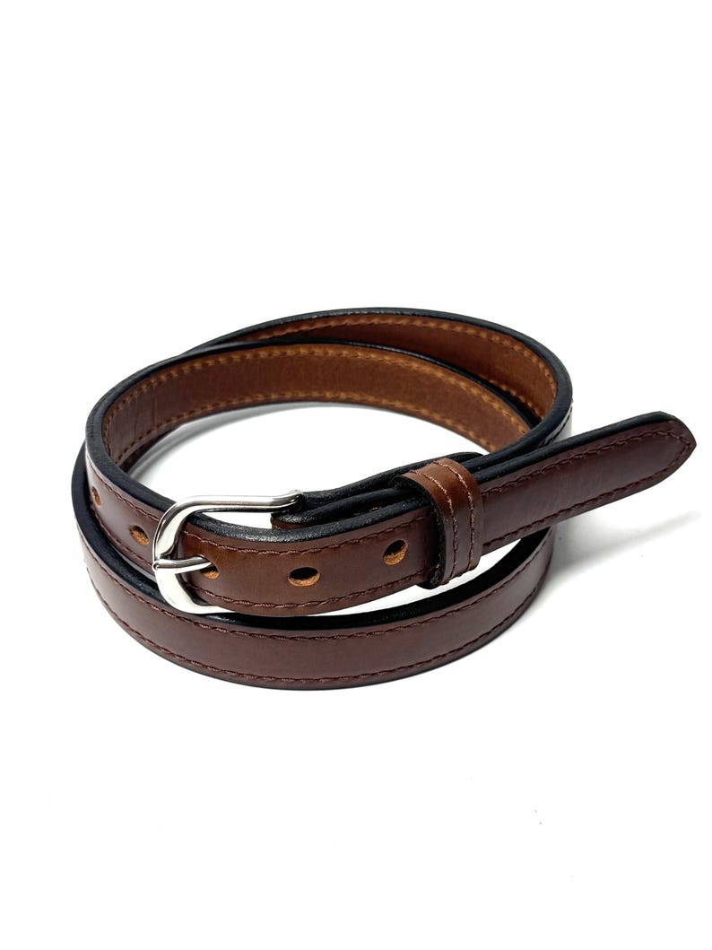 Angled view of brown cowhide raised center belt with dark finished edges