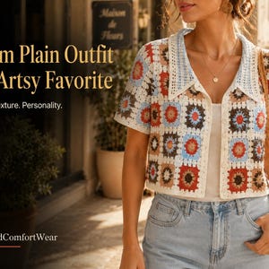 May include: A short-sleeved crochet cardigan featuring a multi-colored granny square pattern in shades of blue, red, brown, and white. The garment has a collared neckline, a button-down front, and is worn over a plain top with light blue denim jeans.