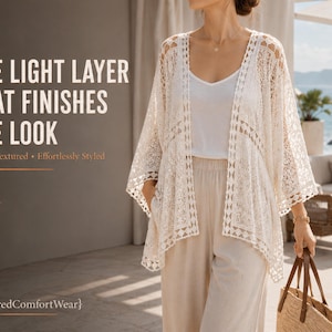 May include: An off-white lace kimono cardigan with an open front and wide sleeves, worn over a white camisole and beige trousers. The image includes the text: THE LIGHT LAYER THAT FINISHES THE LOOK, Airy • Textured • Effortlessly Styled, {LayeredComfortWear}.