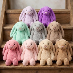 May include: A collection of plush bunny rabbits in various pastel colors, including pink, lavender, green, and tan. The bunnies have long, floppy ears and are arranged on wooden steps. Each bunny has a soft, cuddly appearance.