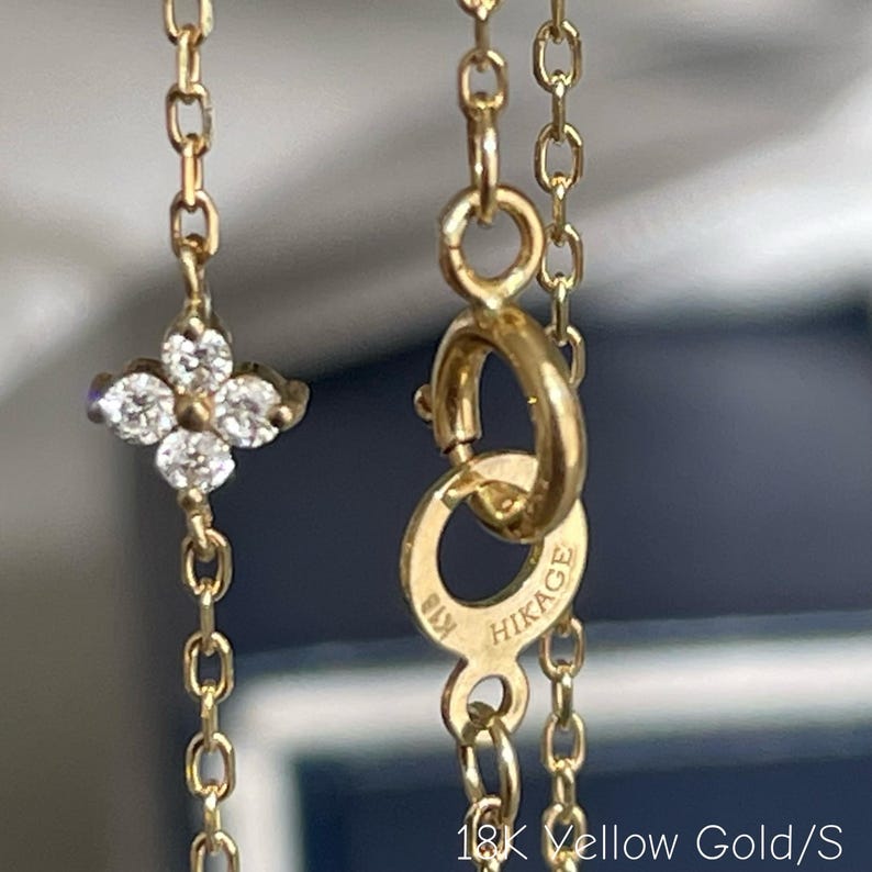 May include: A trio of speckled ceramic mugs with a matte finish. The mugs are in cream, light grey, and dark grey. Each mug features a simple, minimalist design, ideal for tea or coffee.