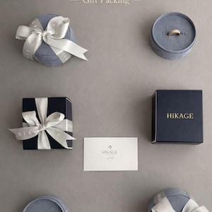 May include: A set of three ceramic mugs with a speckled, matte finish in cream, light brown, and dark brown. Each mug has a simple design and a rounded handle.