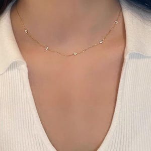 May include: A trio of ceramic mugs with a speckled, matte finish in cream, light grey, and dark grey. Each mug features a minimalist design and a rounded handle.