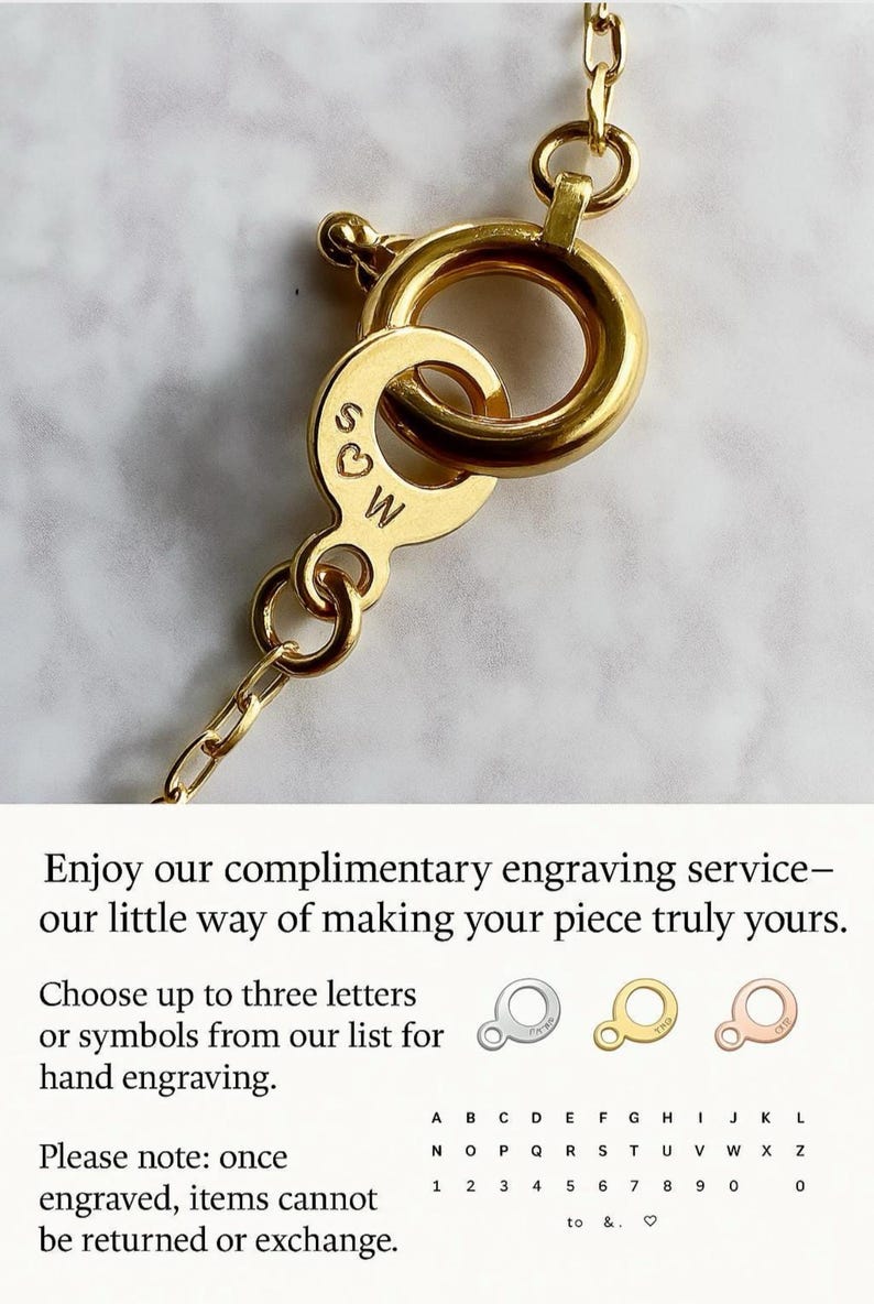 May include: Close-up of a gold necklace clasp with engraved initials "S♡W". The clasp is attached to a fine chain. The image includes text about complimentary engraving services.