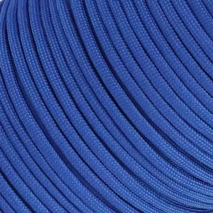 May include: A vibrant royal blue cord featuring a tightly woven, multi-strand construction. The surface of the cord displays a consistent, textured pattern of diagonal lines created by the braided fibers, showing a uniform color throughout the length.
