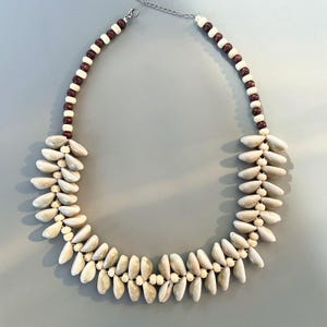 May include: A set of three ceramic mugs with a speckled, matte finish in cream, light grey, and dark grey. Each mug has a simple, minimalist design, suitable for coffee or tea.