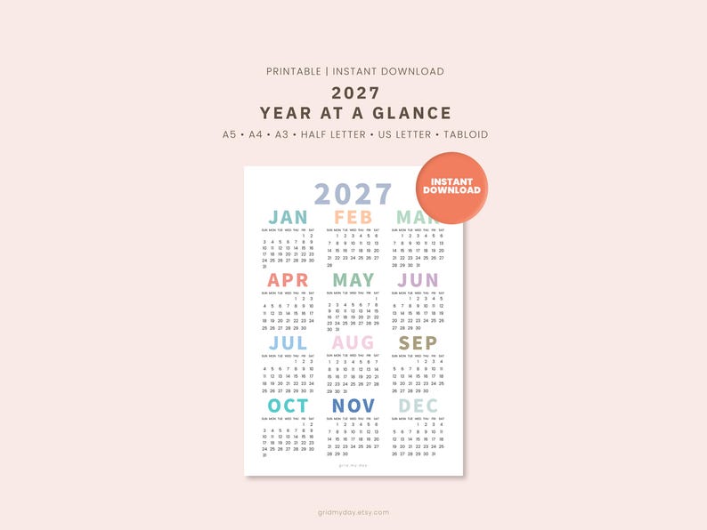 May include: A 2027 year at a glance printable calendar featuring twelve months arranged in a grid. Each month name is displayed in a different pastel color with corresponding dates below. A circular orange badge reads INSTANT DOWNLOAD.