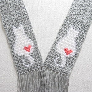 Cats and Hearts scarf crochet pattern. Instant download instructions to make this gray scarf with white cat silhouettes and coral hearts