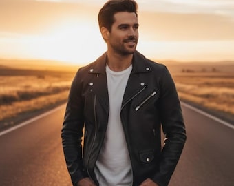 May include: A black leather jacket with silver zippers and buttons. The jacket is worn over a white t-shirt. The person is standing on a road with a sunset in the background.