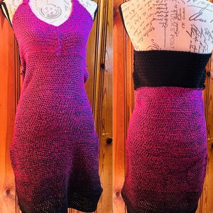 May include: A handmade halter dress in a gradient of pink to black. The crochet dress features a halter neckline and a fitted silhouette. The back view shows a black band at the waist. The dress is displayed on a mannequin.