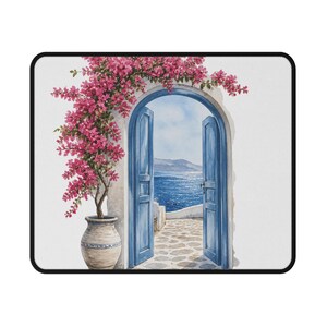 May include: A rectangular mouse pad featuring a watercolor illustration of an arched doorway with open blue doors. A large terracotta pot with vibrant pink bougainvillea flowers sits to the left. The view through the door shows a stone patio.