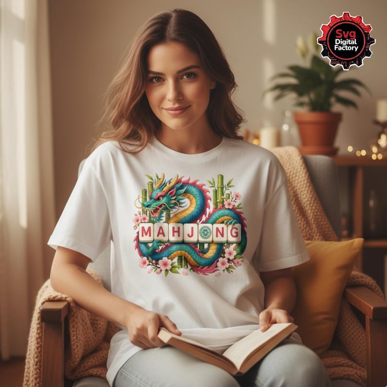 May include: White t-shirt featuring a colorful dragon design with the word "MAHJONG" in block letters. The dragon is teal, yellow, and blue, surrounded by pink flowers and bamboo. The shirt is a casual wear item.