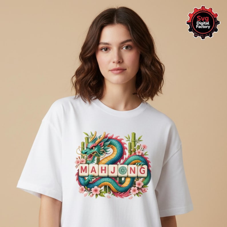 May include: White t-shirt featuring a colorful dragon design with the word "MAHJONG" in block letters. The dragon is teal, blue, and red, with bamboo and pink flowers. The shirt is a casual, everyday wear item.