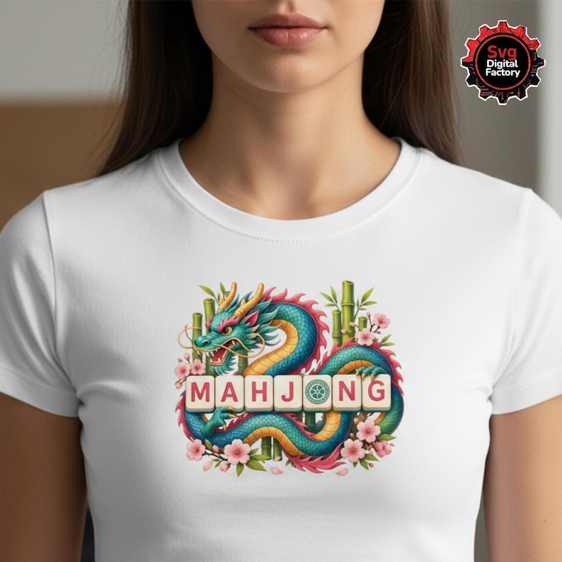 May include: White t-shirt featuring a colorful illustration of a dragon with the word "MAHJONG" in tiles. The dragon is teal, blue, and pink, surrounded by bamboo and pink flowers. The design is centered on the shirt.