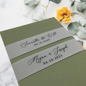 May include: Olive green wedding invitation with two translucent bands. The top band reads "Samantha & Will 08.16.2025" in elegant script. The bottom band reads "Megan + Joseph 06.28.2025". Decorative floral elements are in the background.